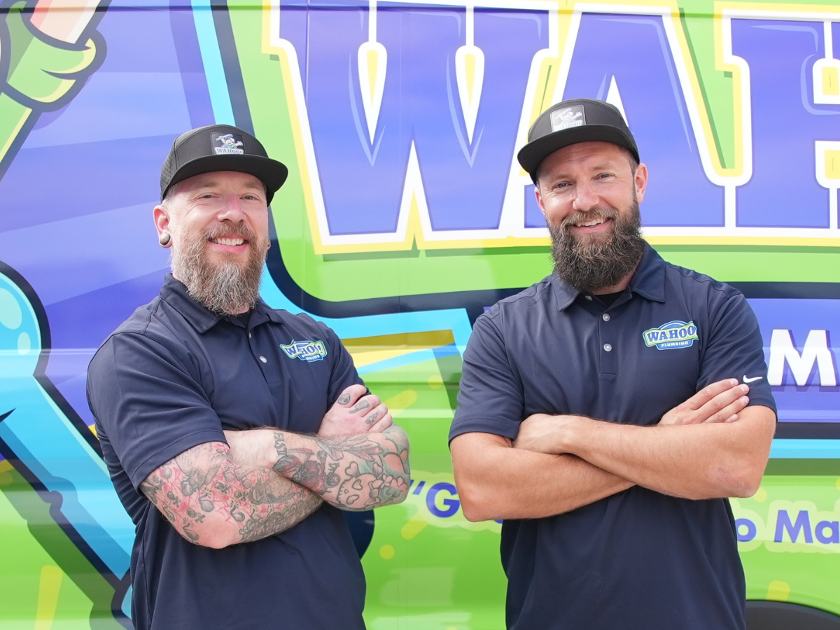 Wahoo Plumbing technician greeting a happy homeowner